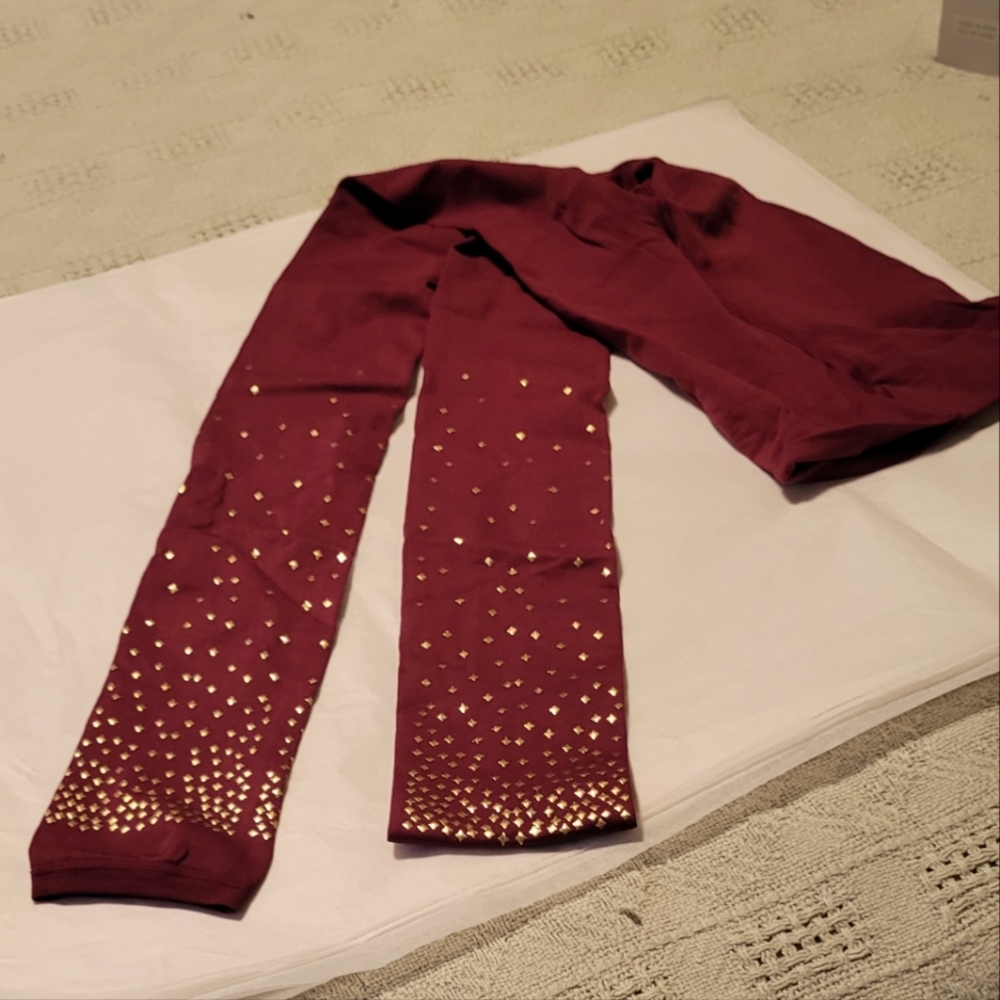 Light weight burgundy leggings with gold stars in lower leg
